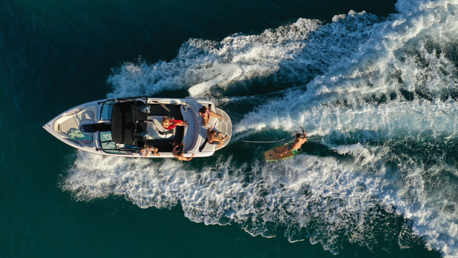 Aerial view of a wakeboat towing a wakeboarder